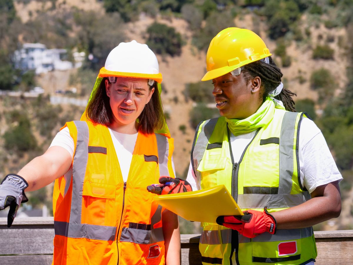 Two technicians reviewing work on site